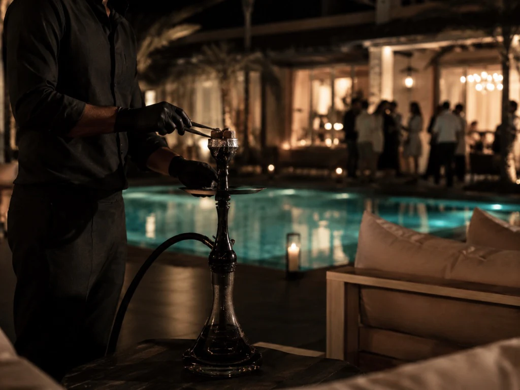 Hookah master serving guests by the pool